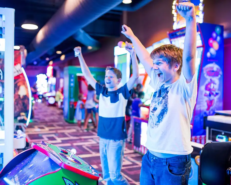 Boys cheering while playing arcade games at Pro Bowl West in Fort Wayne, IN
