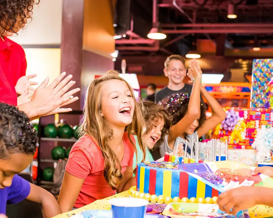 Kids celebrating a birthday party with cake at Pro Bowl West in Fort Wayne, IN
