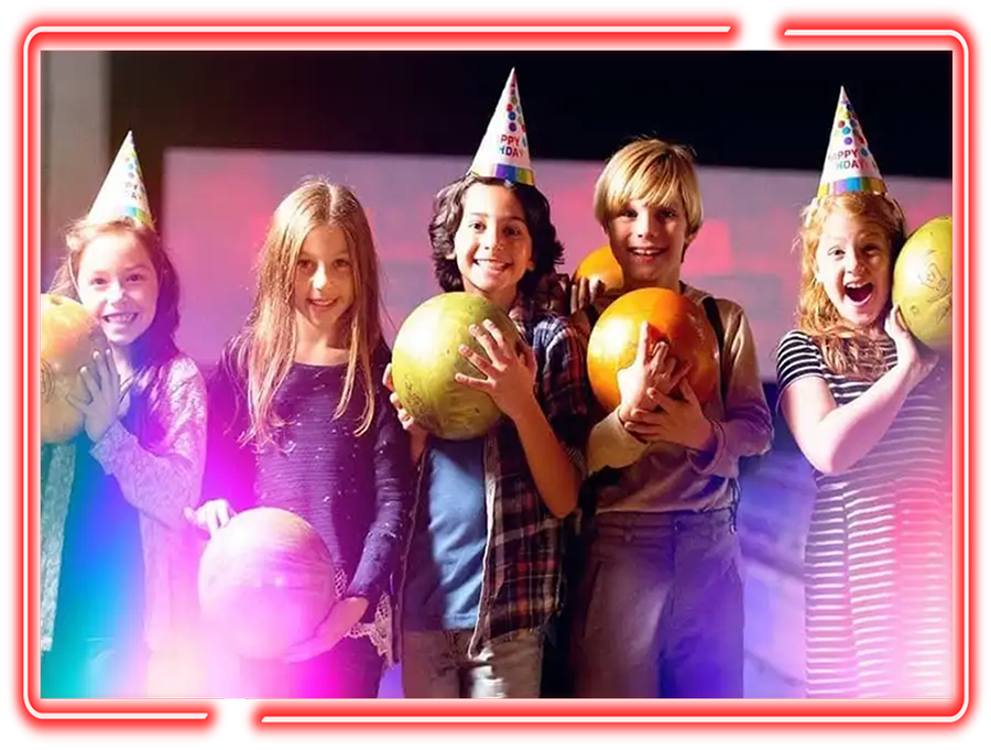 Kids wearing birthday hats and holding bowling balls at Pro Bowl West in Fort Wayne, IN