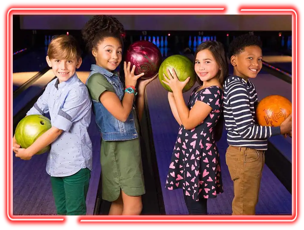 Kid Parties - Kids posing with bowling balls on the lanes at Pro Bowl West in Fort Wayne, IN