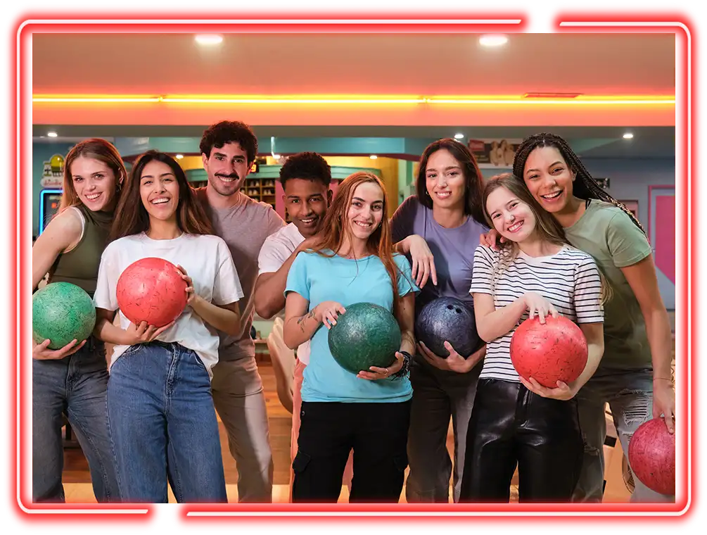 Group of young adults holding bowling balls before a game at Pro Bowl West in Fort Wayne, IN - Ultimate Unlimited Parties
