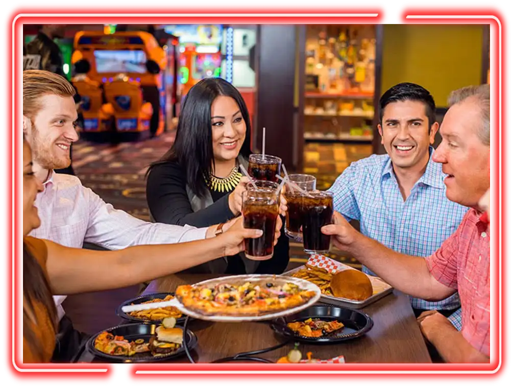 Coworkers toasting drinks over shared appetizers before bowling game at Pro Bowl West in Fort Wayne, IN as part of a team building event